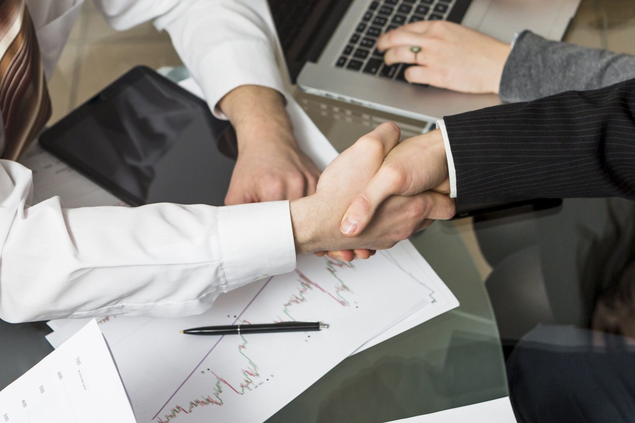 close up two businesspeople shaking hands