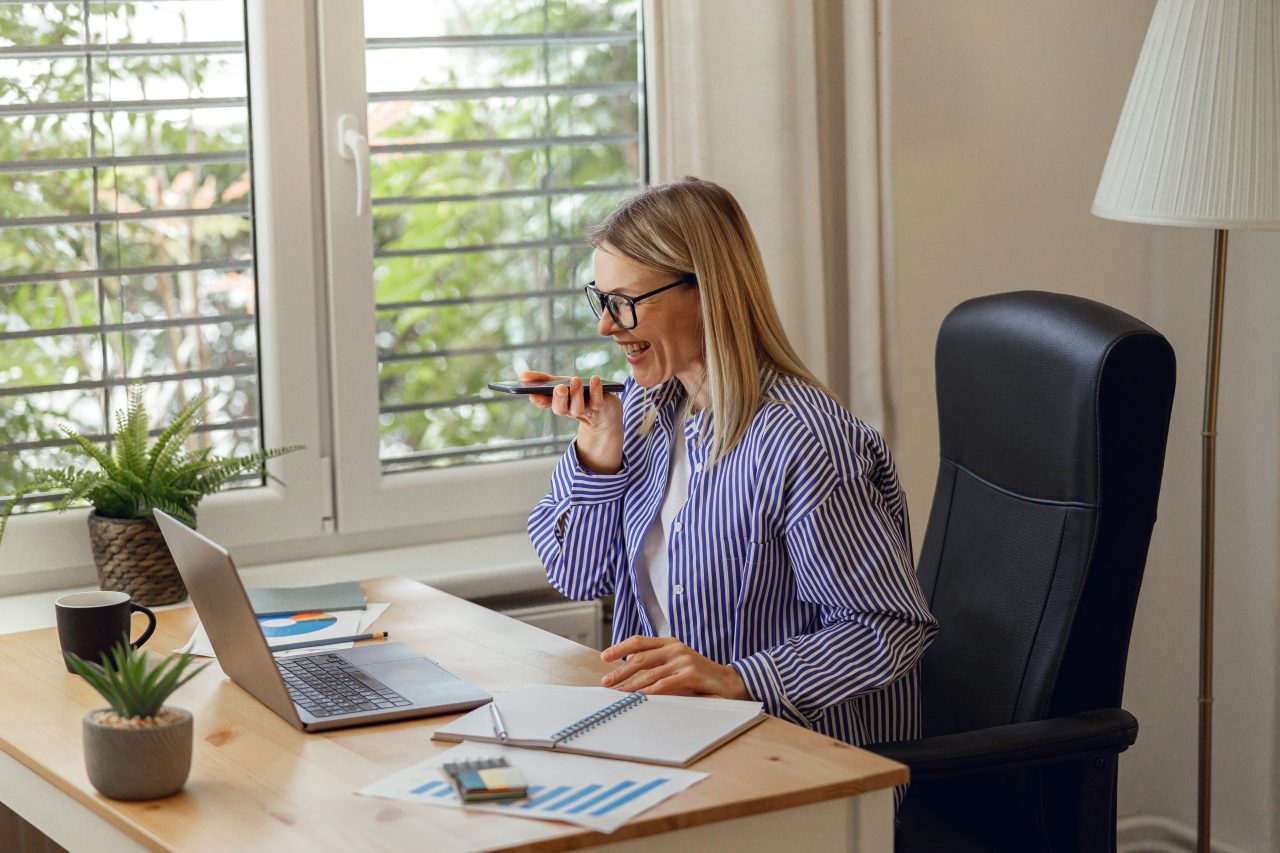 businesswoman accountant recording audio message colleagues work day from home office