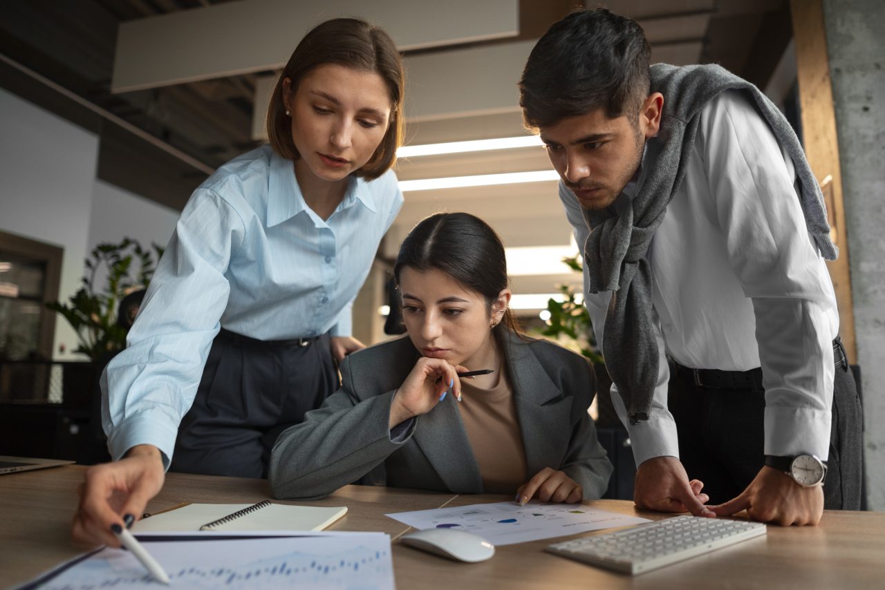 people analyzing checking finance graphs office